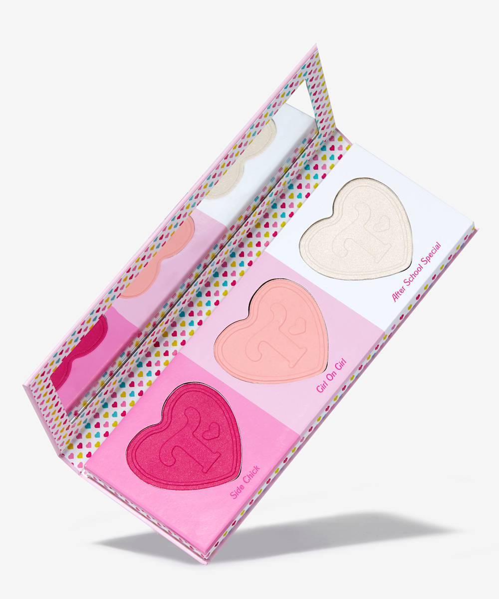 three heart shaped blushes in a palette with a mirror